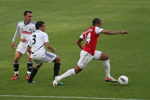 Theo Walcott of Arsenal defended by Leon Britton and Neil Taylor of Swansea.