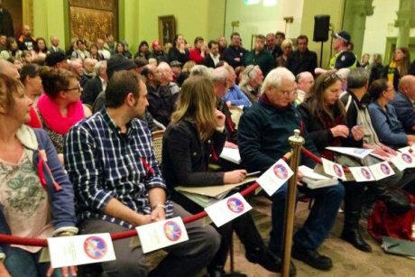 Anti-mosque campaigners hold fliers explaining their opposition to Islam at a Bendigo Council meeting.