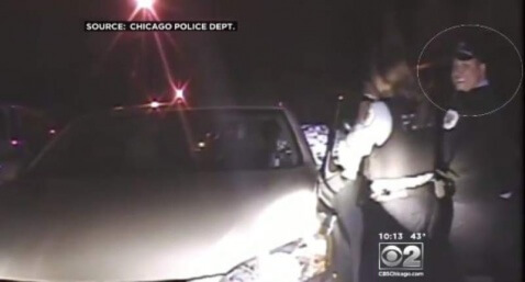 Officer Jose Lopez caught smiling on dashcam video while his partner attacks Catherine Brown in a May 2013 encounter. (WBBM-TV)