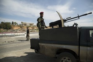 A Syrian soldier keeps watch near Maarzaf, about 15 kilometers west of Hama, Syria, Wednesday, March 2, 2016. Local leaders and elders signed a declaration pledging to abide by a truce in Maarzaf.