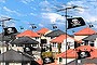 Film and TV piracy in the suburbs. 
Dense neighbourhood, Pirate Flags, Downloading. 
Digitally altered image by Judy Green