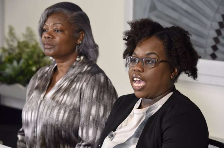 Edson Thevenin's mother, Gertha Depas, left, and his wife, Cinthia Thevenin, speak to the media about the investigation into his fatal shooting by Troy police on April 17, 2016. (Skip Dickstein/Times Union)