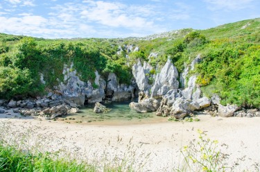 ​Gulpiyuri Beach, Spain: What is a sandy beach doing in the middle of a meadow, 100 metres from the sea? Gulpiyuri ...