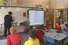 Video still: An ACT teacher teaches children in a classroom