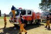 A NSW Rural Fire Service crew from the Devils Pinch brigade take some time to rest and clean their truck at a staging area at Penrith