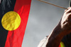 An elder with the Wurundjeri tribe holds an Aboriginal flag during Sorry Day in Melbourne on May 26, 2007.