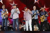 FILE - In this July 3, 2014, file photo, The Beach Boys, including original members Mike Love, second from left, and Bruce Johnston, third from left, perform at the Hatch Shell on the Esplanade in Boston. The Beach Boys will be on