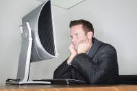 Civilian man in a suit with a computer