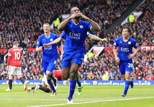 Leicester's Wes Morgan, centre, celebrates after scoring during the English Premier League soccer match between Manchester United and Leicester at Old Trafford Stadium, Manchester, England, Sunday, May 1, 2016.