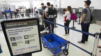 Faced with the prospect of long wait times at airports this summer, Homeland Security is boosting its checkpoint staffing. In this photo from December, passengers line up to go through security at the Fort Lauderdale-Hollywood International Airport.