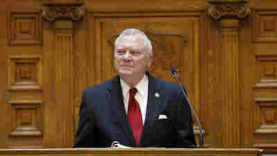 Gov. Nathan Deal says that a bill making it legal to carry guns in most buildings and areas at public colleges is too broad. He's seen here at the end of the General Assembly's session in March.