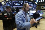 Trader Peter Mancuso, center, works on the floor of the New York Stock Exchange, Friday, Oct. 23, 2015.