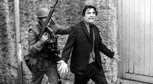 John Hume is detained by soldiers during a civil rights protest in Londonderry in August 1971.