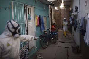 Municipal workers sprays insecticide to combat the Aedes aegypti mosquitoes that transmits the Zika virus at the Imbiribeira neighborhood in Recife, Pernambuco state, Brazil, Tuesday, Jan. 26, 2016.