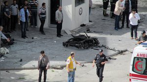 File - Security and forensic officials and medics investigate around the remains of a car after an explosion outside a police station in Gaziantep, Turkey, Sunday, May 1, 2016.