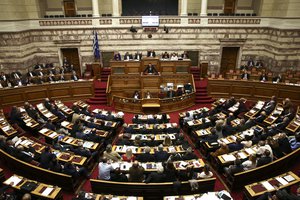 Greece's Prime Minister Alexis Tsipras addresses lawmakers during a parliamentary session in Athens, on Sunday, May 8, 2016.