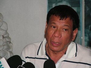 Davao City Mayor Rodrigo Duterte answers questions from reporters during a press conference at the Roman Catholic Cemetery in Davao City, Philippines.