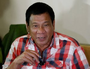 Front-running presidential candidate Mayor Rodrigo Duterte gestures during his second news conference after voting in a polling precinct at Daniel R. Aguinaldo National High School, Matina district, his hometown in Davao city in southern Philippines Monday, May 9, 2016.