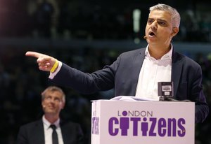 Candidate for London Mayor Sadiq Khan speaks while Zac Goldsmith, left, listens during an assembly at the London Mayor election event of London Citizens in London, Thursday, April 28, 2016.