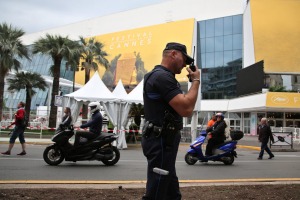 A police officer patrols in front of the entrance of the Festival Palace in Cannes, southern France, Tuesday, May 10, ...