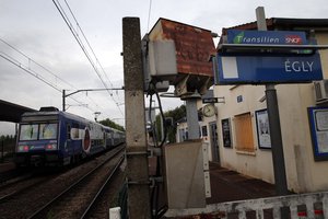 A train stops at the Egly station, south of Paris, Wednesday, May 11, 2016.