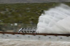 A sled speeds down a track during a test of a Hyperloop One propulsion system, Wednesday, May 11, 2016, in North Las Vegas, Nevada.