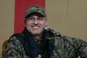 This undated handout image released on Friday, May 13, 2016, by Hezbollah Media Department, shows slain top military commander Mustafa Badreddine smiling during a meeting.