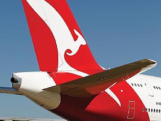 06/09/2012 BUSINESS: The Qantas Airways Ltd. logo is displayed on the tail of an aircraft during a media event in Sydney, Australia, on Thursday, Sept. 6, 2012. Qantas formed an alliance with Emirates Airline to coordinate prices and schedules, while scrapping a similar deal with British Airways, as the carrier tries to reverse losses on long-haul routes. Photographer: Brendon Thorne/Bloomberg