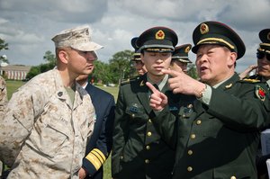 The People’s Republic of China Minister of National Defense Gen. Liang Guanglie asks Gunnery Sgt. Myron Tapio, the battalion gunner master for 2nd Tank Battalion, 2nd Marine Division, a question about the M1A1 Abrams Battle Tank on display at Marine Corps Base Camp Lejeune, N.C., May 9. During the visit, II MEF Marines showcased several Marine Corps vehicles and equipment sets to highlight the Corps’ emphasis on training and professional development and its capabilities and role in U.S. and global security.   Liang and the rest of the Chinese delegation are in the midst of a tour of several military installations on the East and West Coasts at the invitation of U.S. Secretary of Defense Leon Panetta. The purpose of these visits is to highlight the improvement of the U.S.’s capacity to cooperate in areas of mutual interest, such as humanitarian assistance and disaster relief, and addressing non-traditional and transnational security threats and counter-piracy.