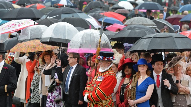 Guests attend a garden party at Buckingham Palace in London on Tuesday. Garden parties have been held at the palace ...