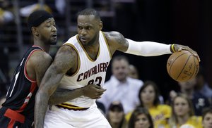 Cleveland Cavaliers' LeBron James (23) looks to drive on Toronto Raptors' Terrence Ross (31) during the first half of Game 1 of the NBA basketball Eastern Conference finals, Tuesday, May 17, 2016, in Cleveland.