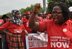 File - People take part in a march that is part of the 'Bring Back Our Girls' campaign, in memory of the Nigerian girls abducted by Nigerian extremists, outside the presidential residence in Abuja, Nigeria, Wednesday, July 8, 2015.