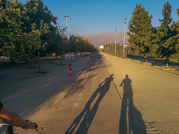 Ricardo Jerez and I bicycling on a path towards his home in Santiago, the Andes looming in the distance.