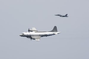 File - An EP-3E Aries, assigned to the "World Watchers" of Fleet Air Reconnaissance Squadron (VQ) 1, left, escorted by an EA-18G Growler, assigned to the "Patriots" of Electronic Attack Squadron (VAQ) 140, performs a flyby over aircraft carrier USS Harry S. Truman (CVN 75).