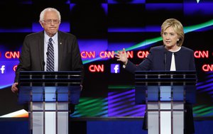 Hillary Rodham Clinton, right, speaks as Sen. Bernie Sanders, I-Vt., listens during the CNN Democratic presidential debate Tuesday, Oct. 13, 2015, in Las Vegas.