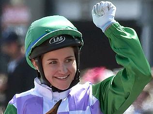 (FILES) A file photo taken on November 3, 2015, shows jockey Michelle Payne celebrating after becoming the first female jockey to win the Melbourne Cup, in Melbourne. Melbourne Cup-winning jockey Michelle Payne is undergoing tests in hospital after falling during a race and complaining of acute abdominal pain, sparking fears of internal injuries, racing officials said May 24, 2016. Australia's Payne -- the first woman to win the 155-year-old Melbourne Cup last year -- tumbled from her horse Dutch Courage at Mildura in northwest Victoria state on Monday and was taken to a nearby hospital. / AFP PHOTO / PAUL CROCK / IMAGE RESTRICTED TO EDITORIAL USE - STRICTLY NO COMMERCIAL USE