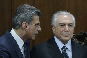 Brazil's acting President Michel Temer, right, talks with Planning Minister Romero Juca, during meeting to deliver to Congress the revision project of the government's fiscal target, in Brasilia, Brazil, Monday, May 23, 2016.