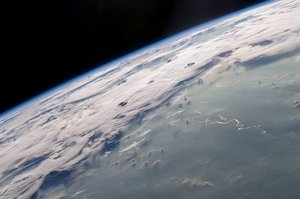 A picturesque line of thunderstorms and numerous circular cloud patterns filled the view as the International Space Station (ISS) Expedition 20 crew members looked out at the limb (blue line on the horizon) of the Earth