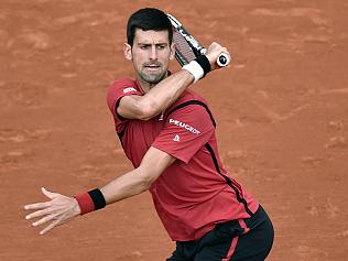 Serbia's Novak Djokovic returns the ball to Taiwan's Lu Yen-Hsun during their men's first round match at the Roland Garros 2016 French Tennis Open in Paris on May 24, 2016. / AFP PHOTO / PHILIPPE LOPEZ