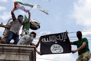 Protesters hold up a flag of the Islamic State of Iraq and the Levant (ISIL),shouts slogans during a protest against Israeli military operations in Gaza.