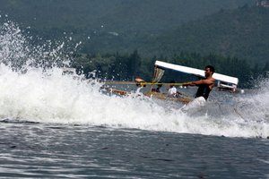 Kashmiri youth shows water skiing skills during a water sports event on the waters of Dal Lake in Srinagar July 22, 2008. indian administrated kashmir.