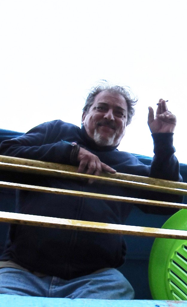 Gorman leans over the railing of a riverboat.