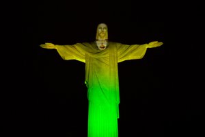 The Christ the Redeemer statue is lit in green and yellow to mark 100 days left to the Olympic Games in Rio de Janeiro, Brazil, Wednesday, April 27, 2016