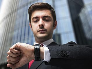 Young businessman looking at his watch