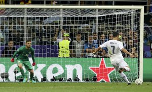 Real Madrid's Cristiano Ronaldo scores the decisive penalty kick during the Champions League final soccer match between Real Madrid and Atletico Madrid at the San Siro stadium in Milan