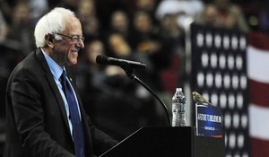 Democratic presidential candidate Bernie Sanders smiles as a bird lands on his podium when he addresses the crowd during a rally at the Moda Center in Portland, Ore., Friday, March 25, 2016.