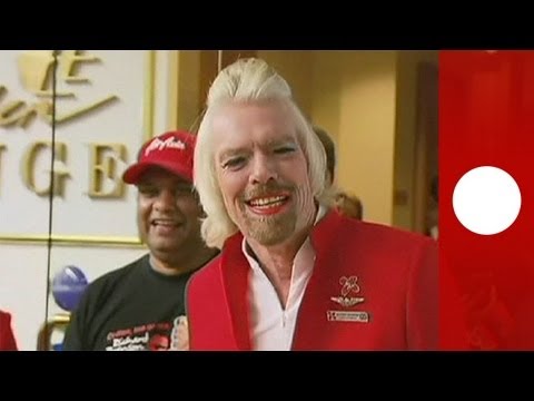 Virgin Group founder Richard Branson works as stewardess for a day