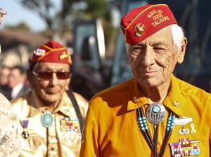 Former United States Marine and Navajo Code Talker Roy Hawthorne, right, leads fellow Marine and Navajo Code Talker Sam Holiday as the arrive for a ceremony honoring the Navajo contribution to the World War II American effort Monday, Sept. 28, 2015, at Camp Pendleton, Calif.