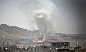 Smoke rises after a Saudi-led airstrike hit a site where many believe the largest weapons cache in Yemen's capital, Sanaa, on Tuesday, April 21, 2015.