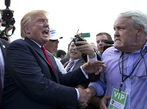 Republican presidential candidate Donald Trump greets a supporters as he works his way through the crowd with security during a rally organized by Tea Party Patriots in on Capitol Hill in Washington, Wednesday, Sept. 9, 2015, to oppose the Iran nuclear agreement.